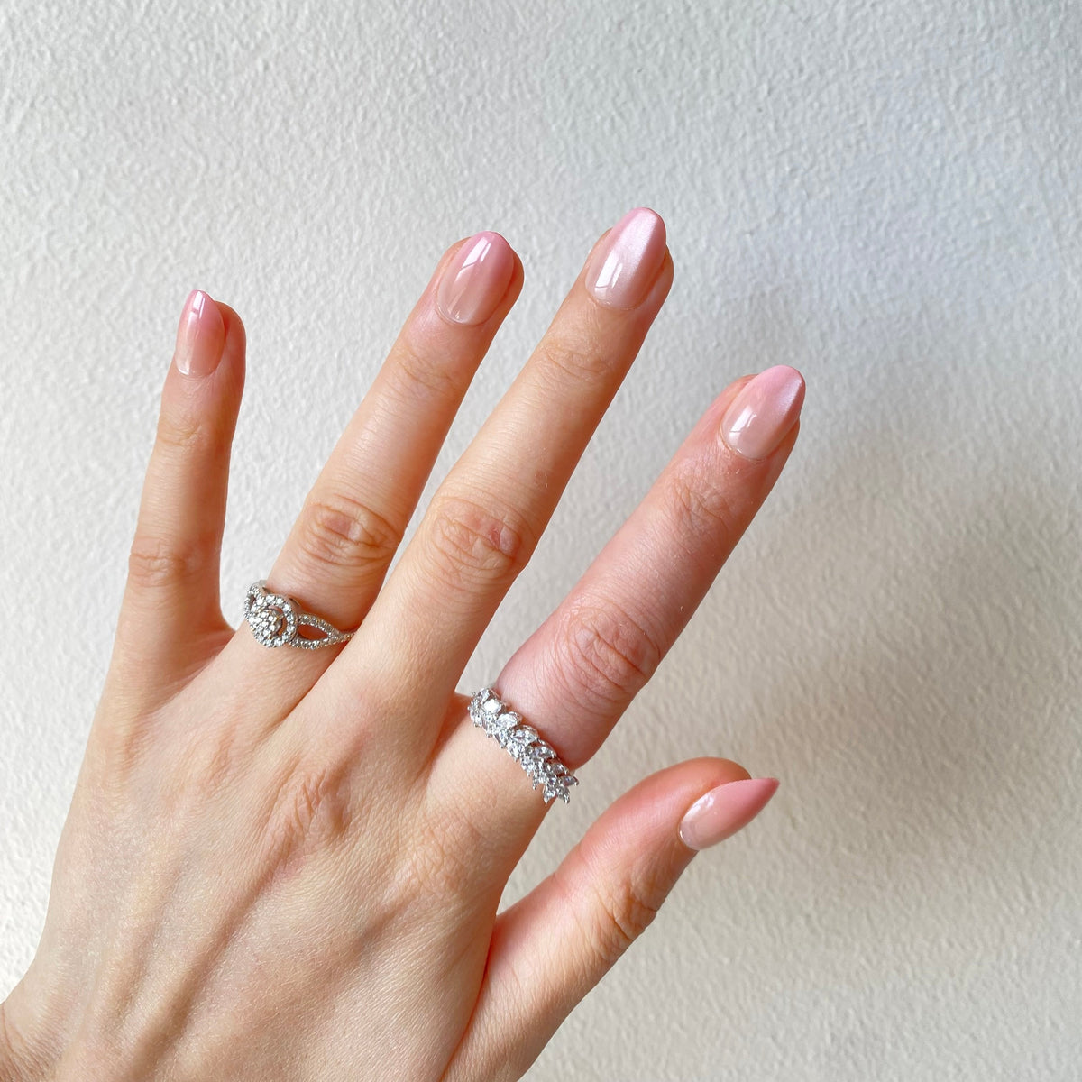 Pearl blush chrome press-on nails flat lay hand spread
