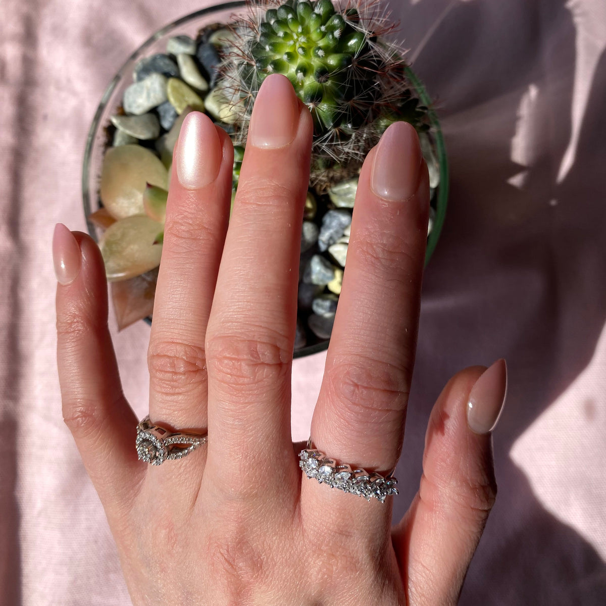 Pearl blush chrome press-on nails on hand with cactus prop